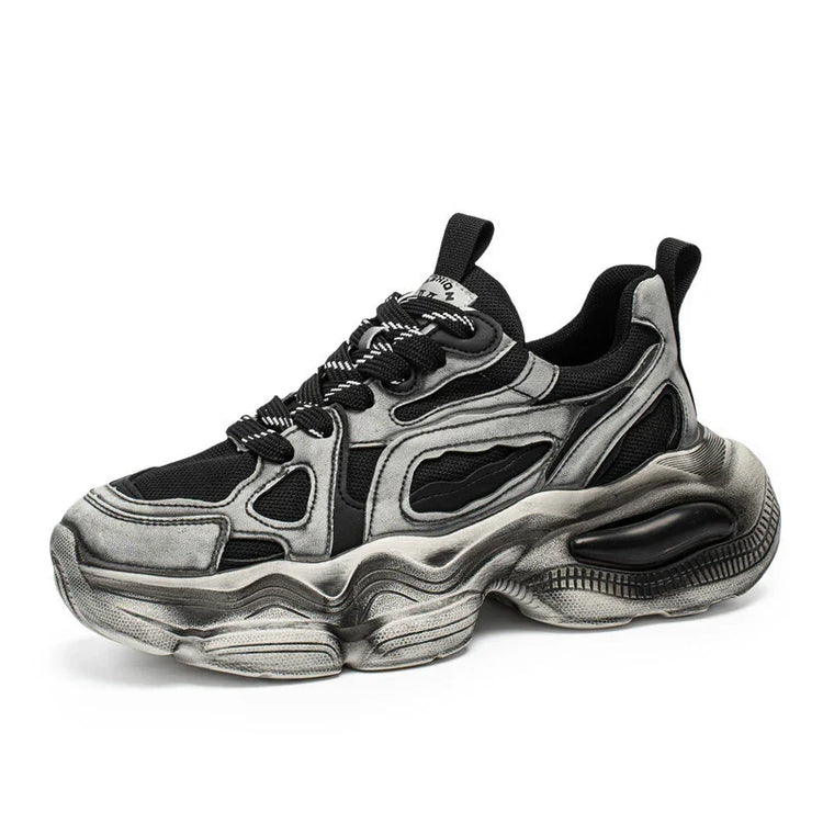 Chunky black and silver streetwear sneaker with mesh panels and thick sculpted sole