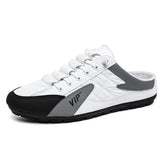 White and gray slip-on sneaker with quilted material, black toe, and casual low-top fit