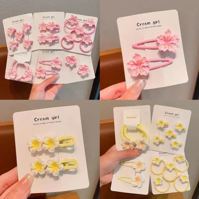 Pastel flower hair clips and earrings sets in pink and yellow, featuring dainty floral designs.