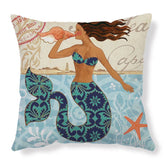 Decorative pillow with artistic mermaid in blue patterned swimsuit, ocean theme, and starfish.