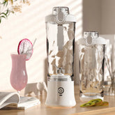 Portable white blender with faceted glass design, modern style, on a kitchen counter