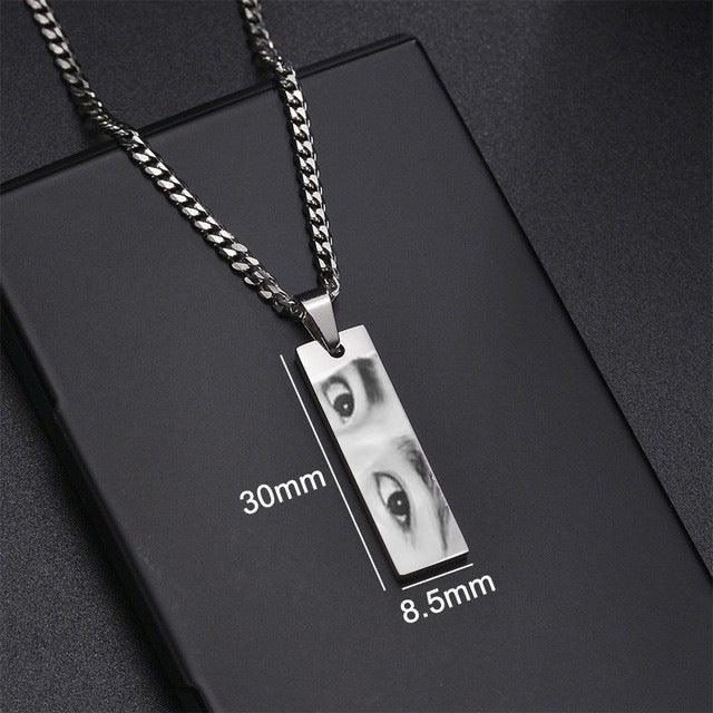 Rectangular silver pendant necklace with engraved eyes, thick chain, minimalist streetwear style