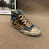 High top sneaker with denim and leopard print panels, gold metallic laces, star studs, distressed finish