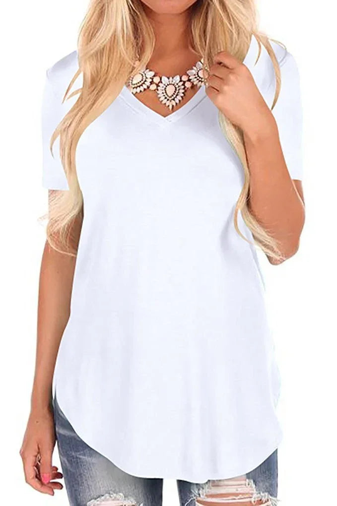 Woman wearing a casual white V-neck short sleeve t-shirt with relaxed fit and distressed denim jeans