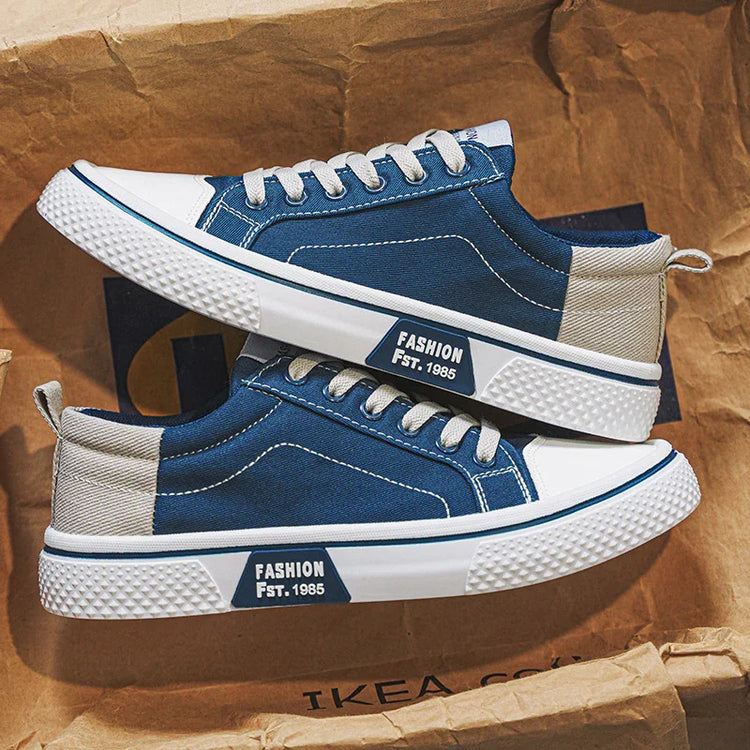 Blue and beige canvas sneakers with white soles and low-top casual streetwear style.