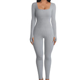 Fitted ribbed grey jumpsuit with long sleeves, square neckline, and stretchy material.