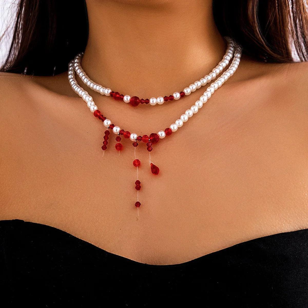 Layered pearl and red crystal beaded necklace, draped fit, worn with a strapless black top