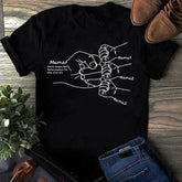 Black cotton t-shirt with white line art of mother and children holding hands, relaxed fit.