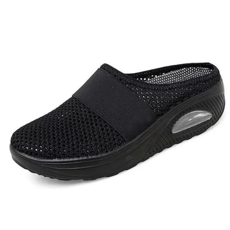 Black mesh slip-on clog with breathable upper and cushioned sole, sporty casual style