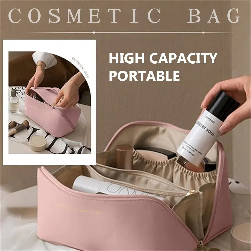 Light pink high-capacity cosmetic bag with zip closure, portable design, smooth material, spacious interior compartments, and elastic pockets, shown storing makeup and skincare items.
