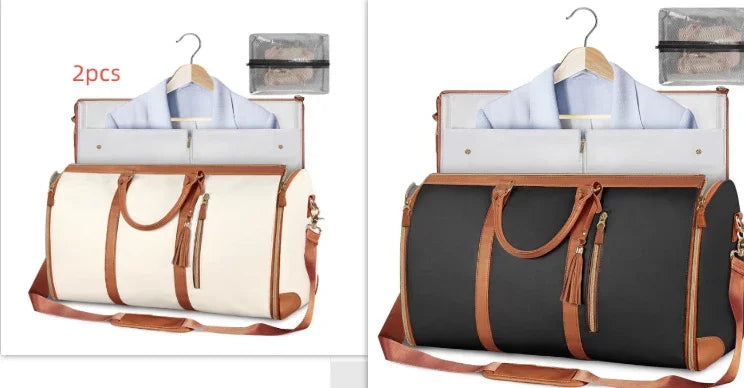 Two travel duffle bags, one cream and one black, with brown leather trim and handles, both holding a light blue dress shirt and laptop, displayed with matching toiletry bags.