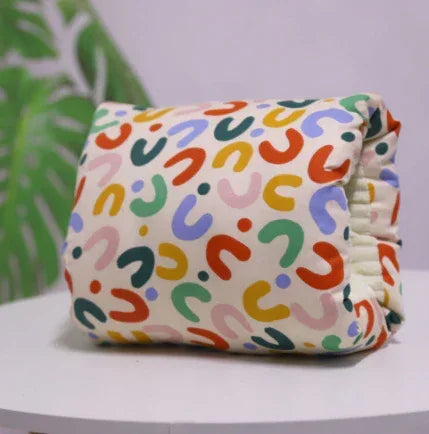 Colorful unisex streetwear accessory with abstract print, soft fabric, relaxed fit.
