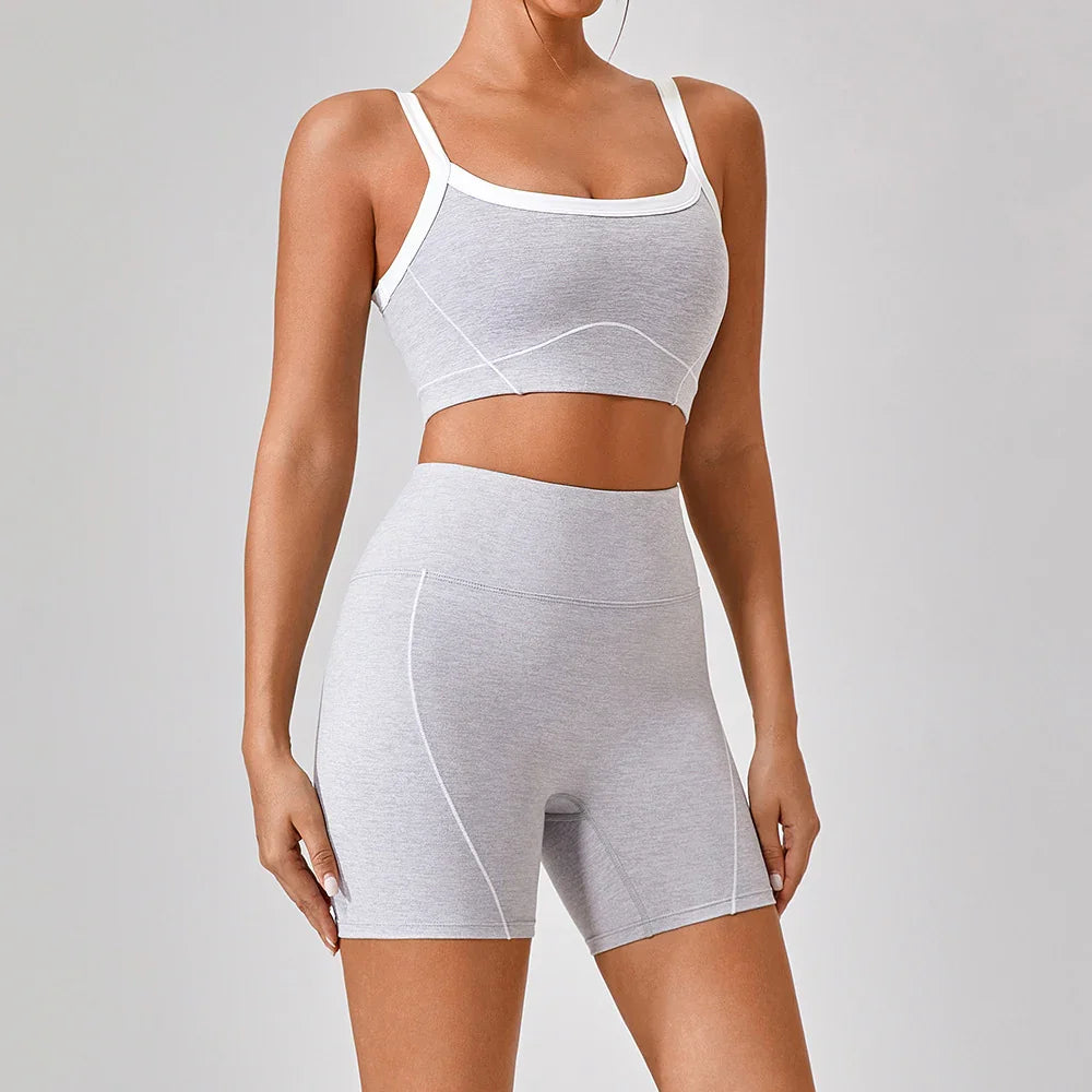 Woman wearing light grey seamless fitted crop top and high-waist biker shorts set