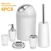 White and silver 6-piece bathroom accessories set including trash can, soap dispenser, toothbrush holder, tumbler, soap dish, and toilet brush.