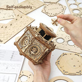 Hands assembling ornate wooden puzzle box from laser-cut pieces, self-assembly kit visible.
