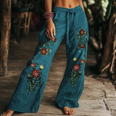 Boho style teal wide-leg pants with colorful floral embroidery, relaxed fit, drawstring waist