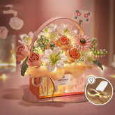 Artificial pink and white floral arrangement with LED fairy lights in a decorative box