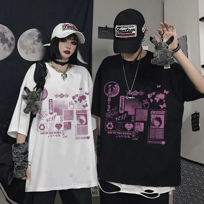 Two people wearing oversized streetwear t-shirts, one white and one black, both with bold purple futuristic graphic prints, loose fit, casual style.