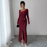 Woman wearing a long-sleeve burgundy ribbed bodycon dress with side slit and ruched waist detail