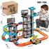 Boy wearing grey printed sweatshirt and joggers, playing with a multi-level plastic toy car racetrack set.
