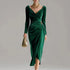 Elegant green velvet dress with long sleeves, draped neckline, slim fit, and ruched waist detail