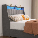 Modern grey upholstered bed with vertical panel headboard, LED shelf, striped pillows, and cozy bedding