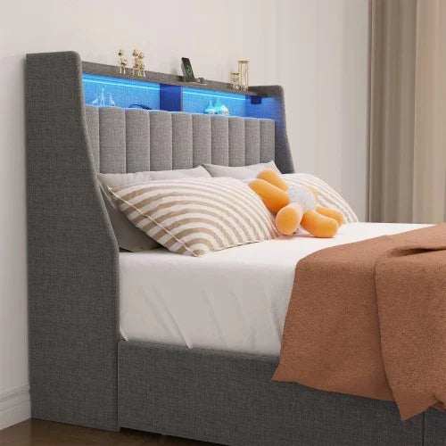 Modern grey upholstered bed with vertical panel headboard, LED shelf, striped pillows, and cozy bedding