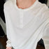 White waffle knit henley long sleeve shirt with relaxed fit and button placket