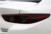 Rear view of a white car showing sleek, modern taillight design with red lens.