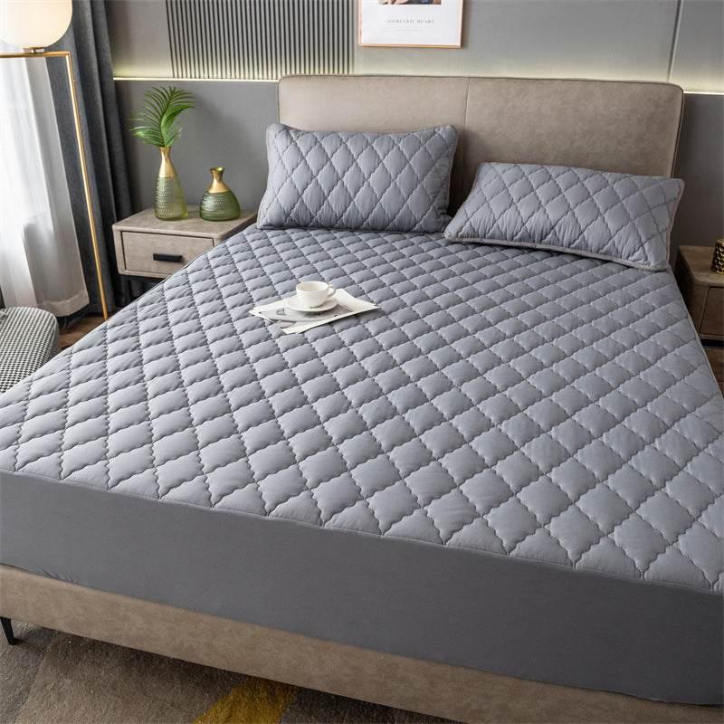 Modern bedroom with gray quilted bedding set, diamond-stitched pattern, soft fitted cover and matching pillows