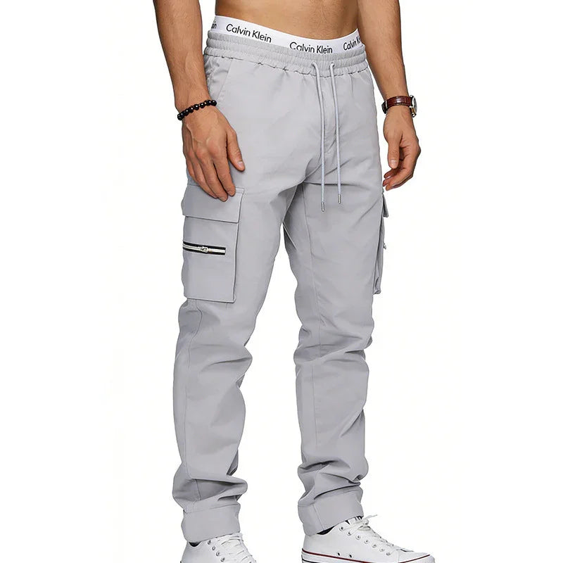 Light gray cargo jogger pants with drawstring waist, side zipper pocket, slim fit style