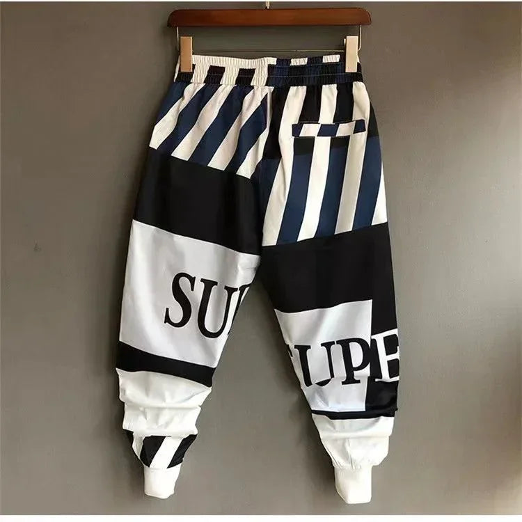 Black and white streetwear jogger pants with bold stripes and relaxed fit