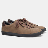 Brown suede low-top sneakers with lace-up closure and black rubber sole, casual streetwear style