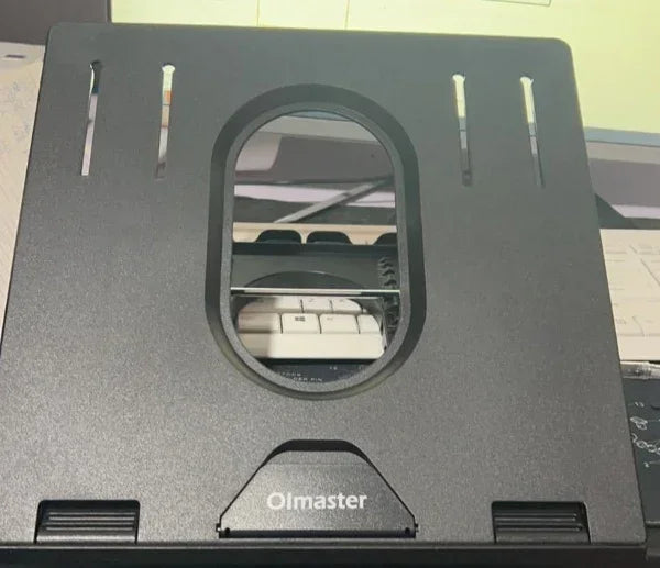 Black adjustable laptop stand with vented design and central oval cutout, made of sturdy plastic.