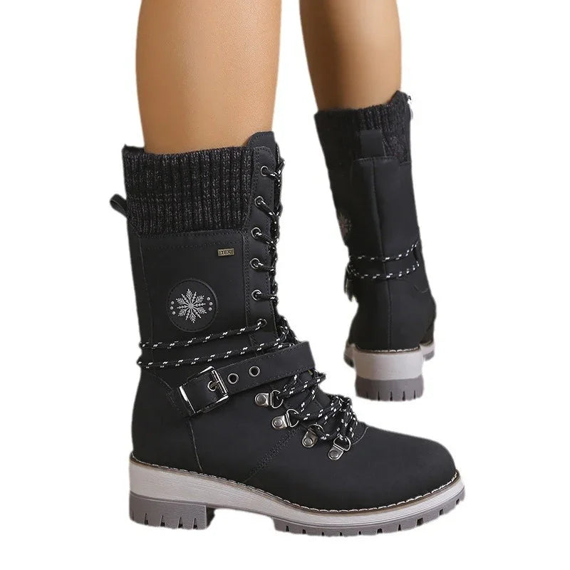 Black lace-up winter boots with knit cuffs, side buckle, and snowflake patch, rugged sole.
