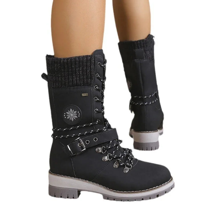 Black lace-up winter boots with knit cuffs, side buckle, and snowflake patch, rugged sole.