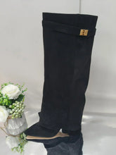 Black suede knee-high boot with gold buckle, pointed toe, and chunky low heel