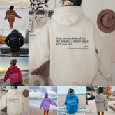 Oversized hoodies in beige, black, pink, blue, and lavender with uplifting text on back, casual fit streetwear style.
