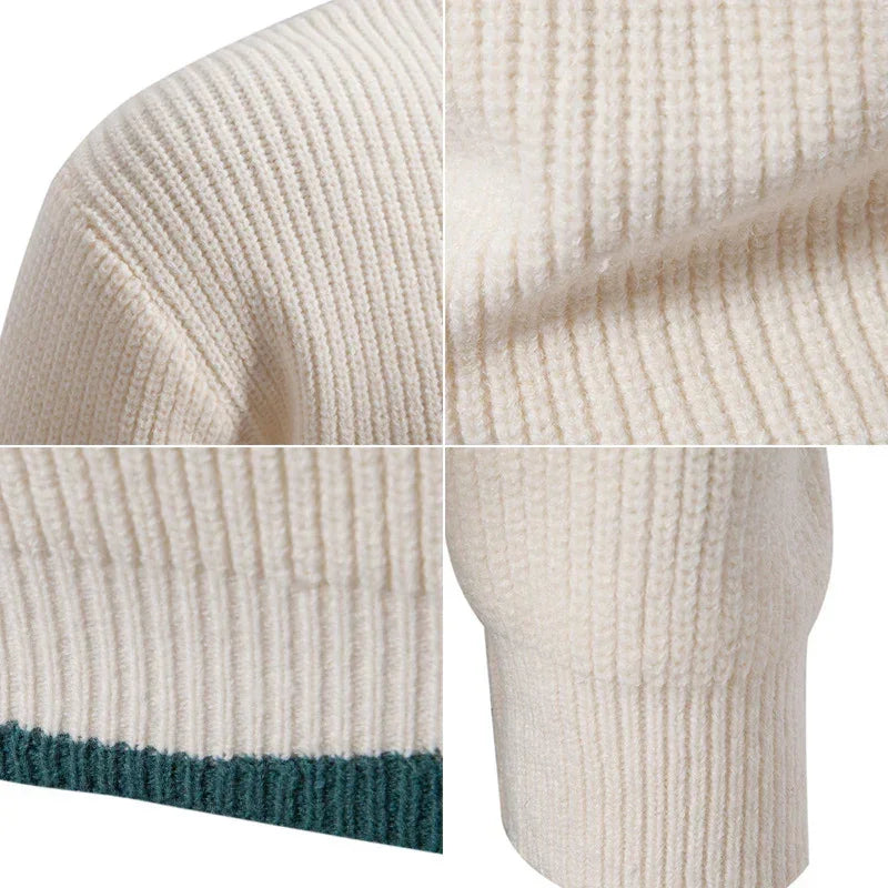 Close-up of cream ribbed knit sweater with green hem, soft texture, relaxed fit.