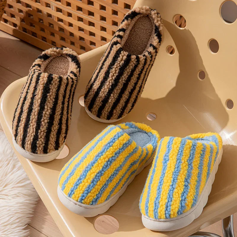 Fuzzy striped slippers in tan-black and yellow-blue, cozy plush material, slip-on style