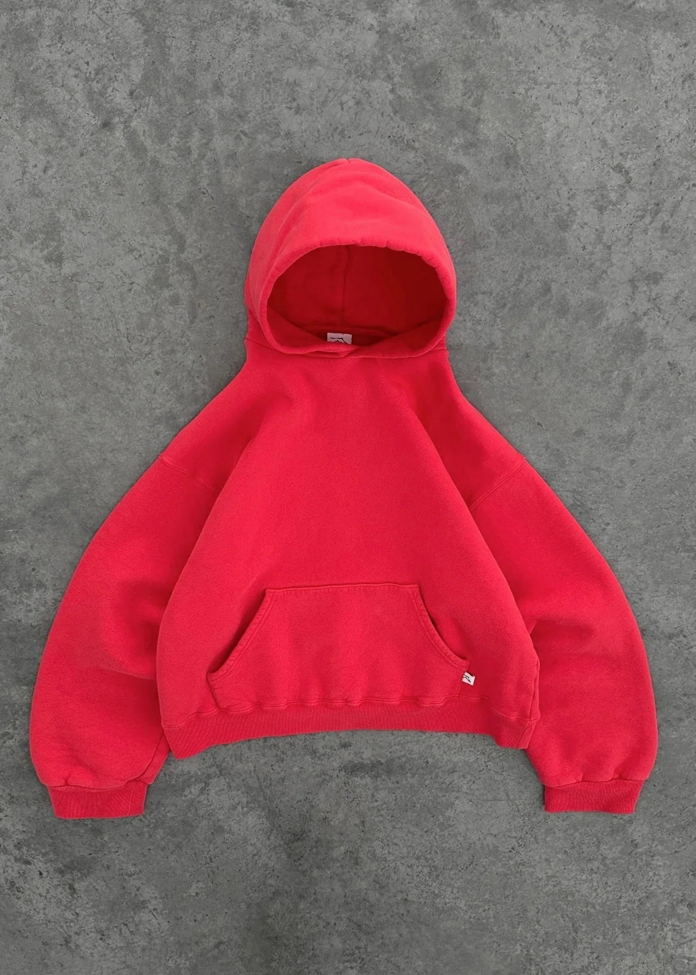 Oversized red fleece hoodie with kangaroo pocket and ribbed cuffs, casual streetwear style