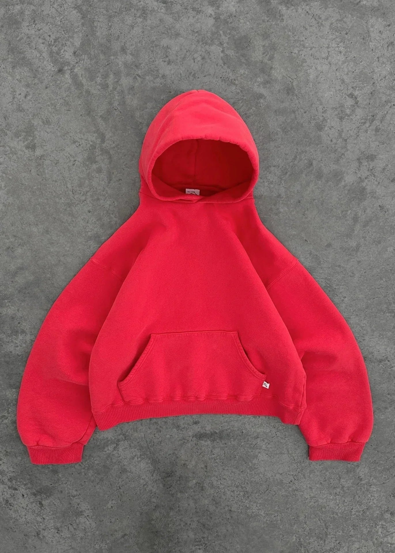 Oversized red fleece hoodie with kangaroo pocket and ribbed cuffs, casual streetwear style
