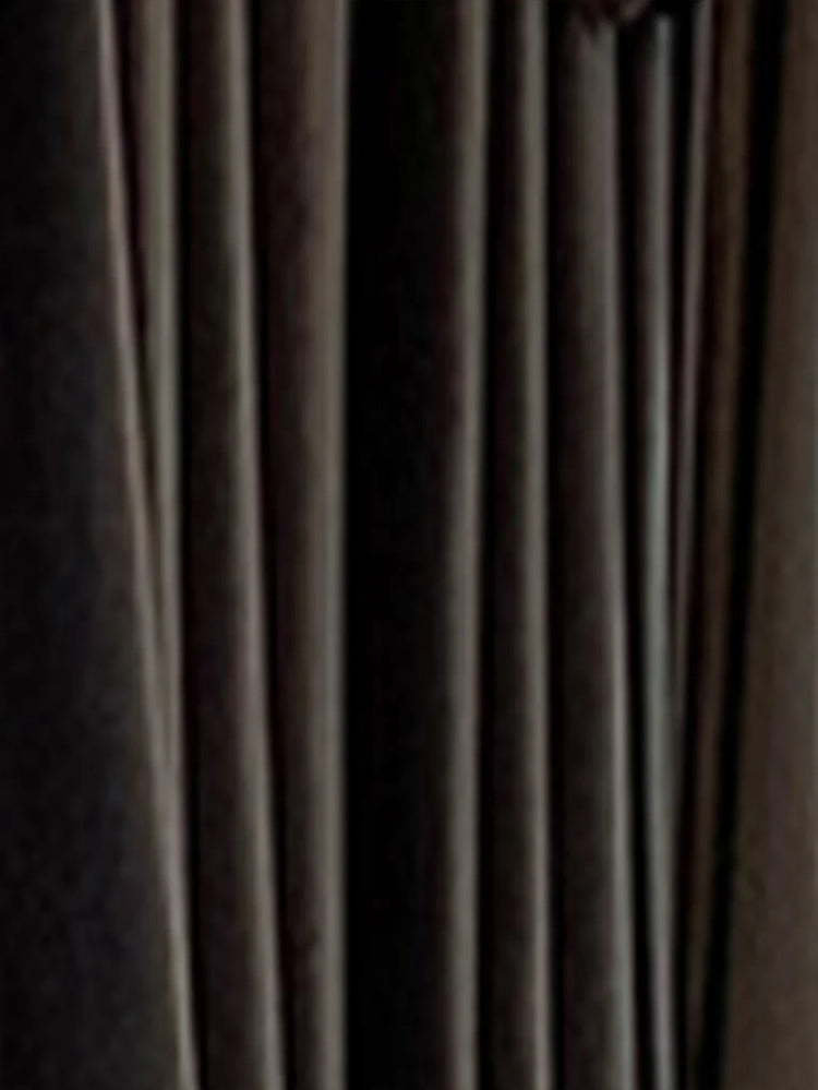 Close-up of black pleated fabric, smooth texture, modern streetwear clothing material