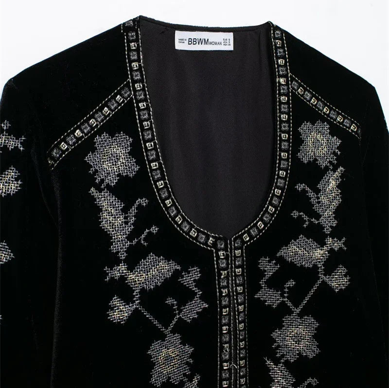 Black velvet top with silver floral embroidery and studded deep V-neck, relaxed fit
