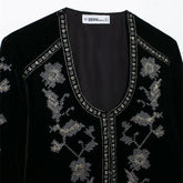 Black velvet top with silver floral embroidery and studded deep V-neck, relaxed fit