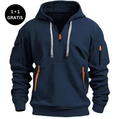 Men's navy blue pullover hoodie with zipper pockets, orange accents, and relaxed fit.
