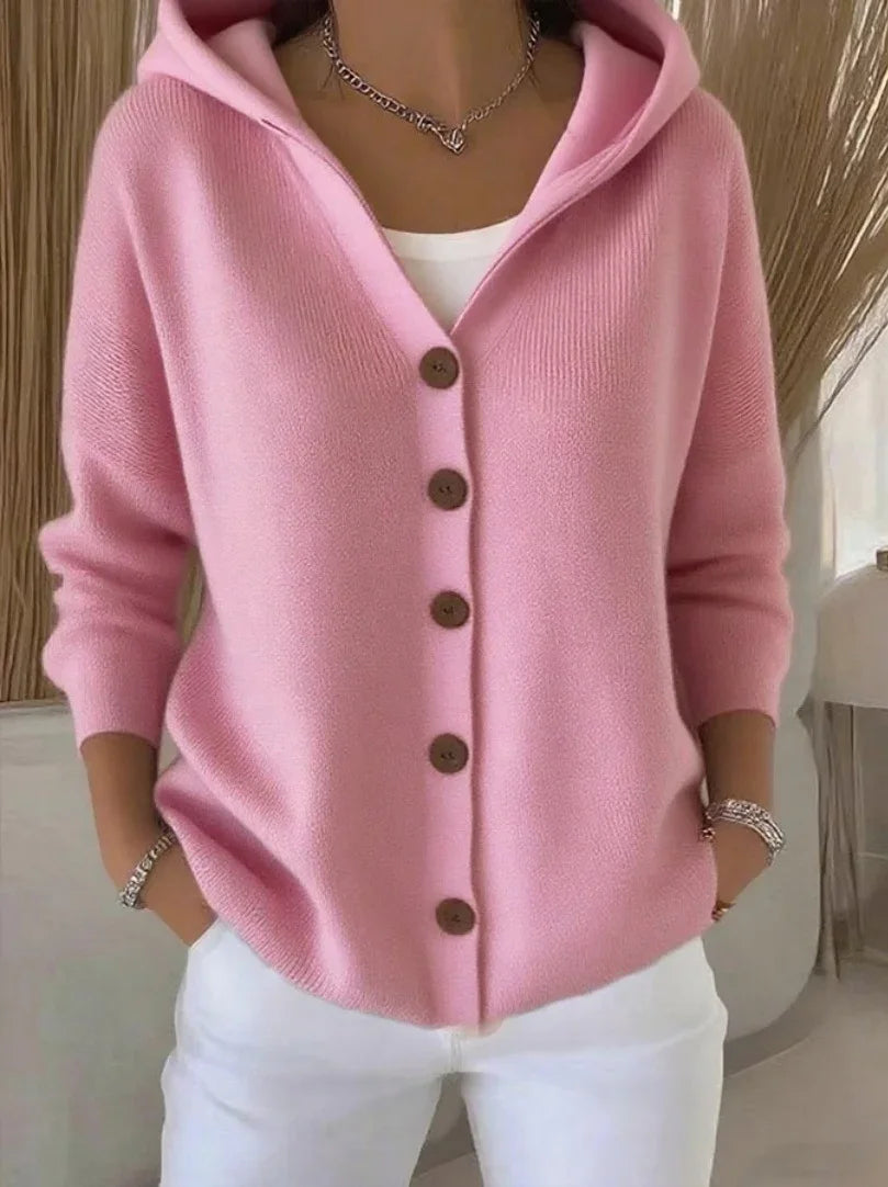 Woman wearing a light pink knit button-up hoodie cardigan with relaxed fit and long sleeves