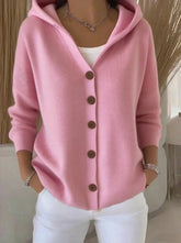 Woman wearing a light pink knit button-up hoodie cardigan with relaxed fit and long sleeves