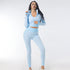 Woman wearing light blue textured seamless zip-up crop jacket and high-waisted leggings set