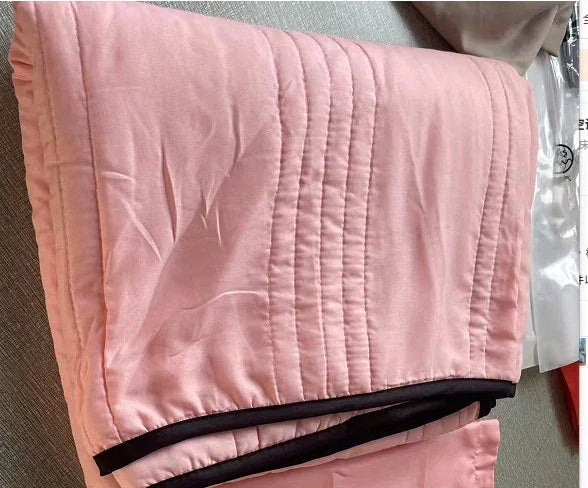 Light pink quilted streetwear jacket with black trim, soft fabric, relaxed fit